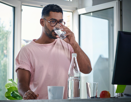 Man drinks water for ACR kidney test.