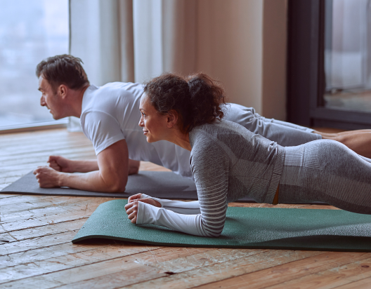 Man and woman do yoga.